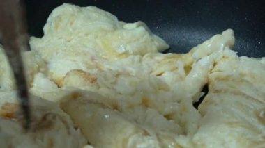 4k, Şef bir tavada bir esnaf yumurta omlet pişirme. Yüksek protein ve demir içeriği ile lezzetli ve besleyici organik yumurta aktif bir tencerede kızartılır.
