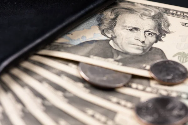 Twenty dollar bill. 20 dollar bill. Image isolated on black background. Fan-shaped tickets introduced in a wallet.