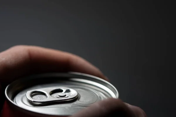 Hand holding a can of cold soda. Cold soft drinks with excess sugar. Not healthy. Cold drinks.