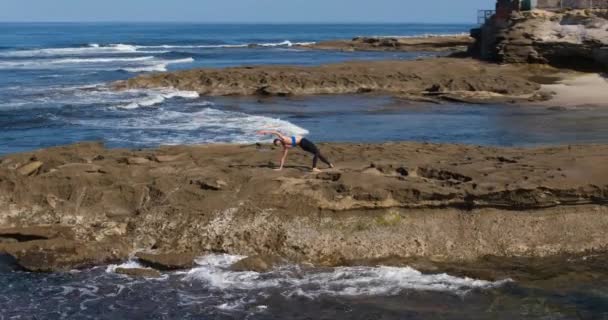 Aerial View Woman Doing Yoga Poses Beach Coastline Sunny Morning — Stock Video