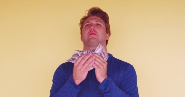 Young Millennial Fanning Himself Money Bright Colored Background Studio — Stock Video