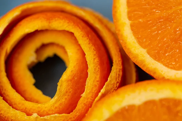 Background with fruits citrus an orange and a peel or pieces of tangerine. Macro image and close-up, concept for healthy food. Top view. Soft focus. Art photography