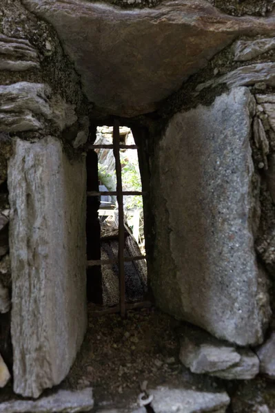 a drywall of stones with window to see through