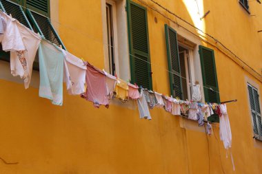 Ligurian sokaklarının tipik görüntüsü: balkonların dışında yatan giysiler
