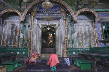 Srinagar, Jammu and Kashmir, India - April 14, 2019 : Muslim woman pray at the Ancient Khanqah-e-Moula, also known as Shah-e-Hamadan wooden Mosque in old town was commissioned by Sultan Sikandar Butshikan in 1395 CE clipart