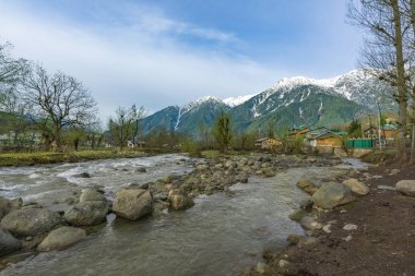Beautiful landscape of the natural Lidder river stream  from the Himalayas mountain passing village of Lalipora Pahalgam, Kashmir,India. It is a popular tourist destination clipart