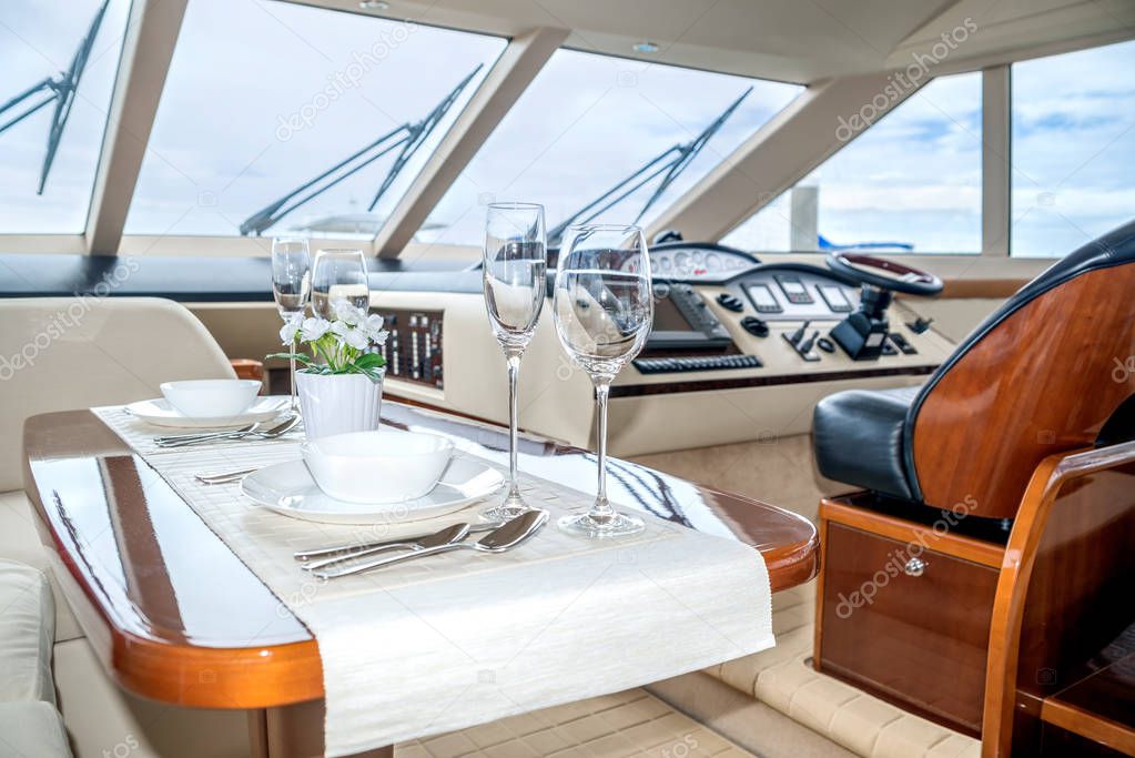 Luxury lunch table setting on a yacht interior comfortable design for holiday recreation tourism travel and vacation concept