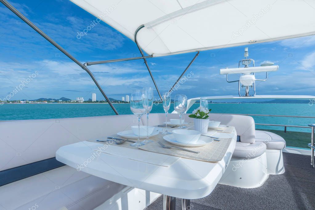 Luxury lunch table setting on a yacht interior comfortable design for holiday recreation tourism travel and vacation concept