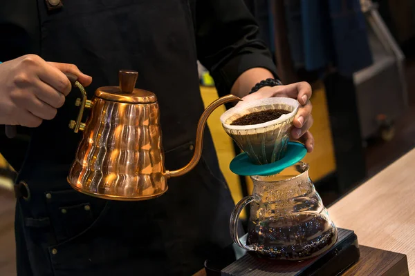 Siphon vacuum coffee maker and coffee grinder with drip brewing filtered coffee or pour-over is a method involves pouring hot water over roasted coffee beans contained in a filter old tradition