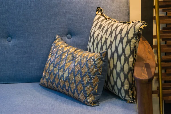 Modern fabric pillows checkered pattern on blue fabric sofa interior decoration