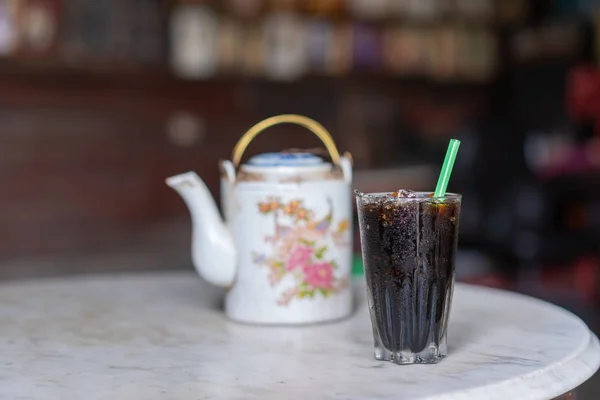 Iced black coffee in the glass Chinese vintage style at Thai Traditional old coffee shop