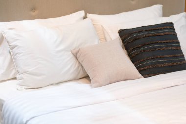 Modern beyaz, kahverengi, bej renkli yastıklar ve kumaştan kanepe iç mimarisi ofis inşaatı ve ev dekorasyonu çağdaş konsept.