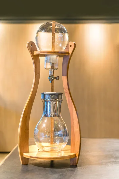 Wooden cold brew Ice drip coffee maker on gray marble counter beverage equipment at the bar and pub or restuarant for drinking refresh relaxation in day life concept.