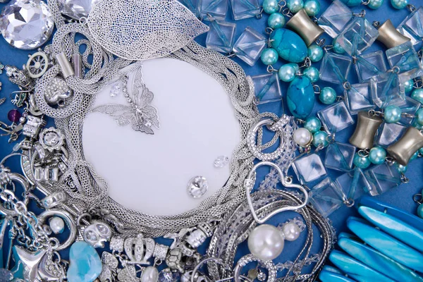 silver jewelry. place for text. Blue and silver ornaments on blue background.