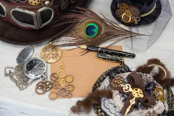 Hats Steampunk or cyberpunk glasses and accessories for women\'s clothing and an empty card for the inscription lie on a light cracked background. The concept of Victorian romance and Gothic