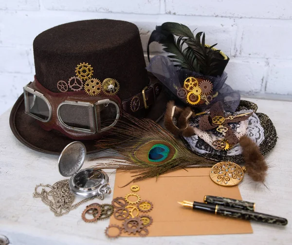 Hats Steampunk or cyberpunk glasses and accessories for women\'s clothing and an empty card for the inscription lie on a light cracked background. The concept of Victorian romance and Gothic