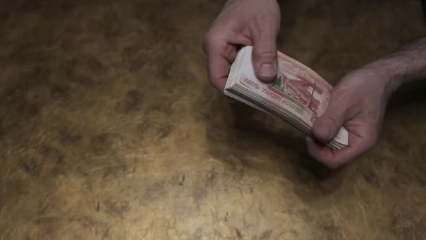 Man Counts Russian Five Thousand Dollar Bills Holding Them Table — Stock Video