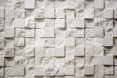 Tekrar eden kareler mozaik, üç boyutlu doku şeklinde duvarla sıvanmış. Dekoratif sıva karelerinin gri arka planı. Desenli Duvar Kağıdı.