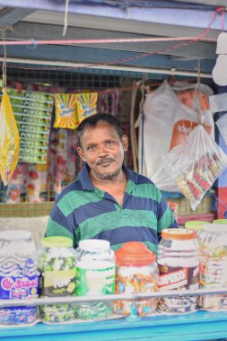 Kolkata, India-July 27,2019: Shopkeeper selling goods at Patuli Floating Market, Kolkata, India. clipart