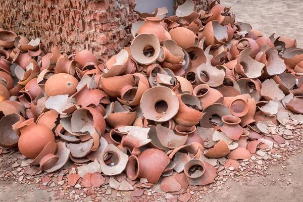 Picture of pile of broken Clay Pottery or Earthenware or traditional Jar on abandoned hut.