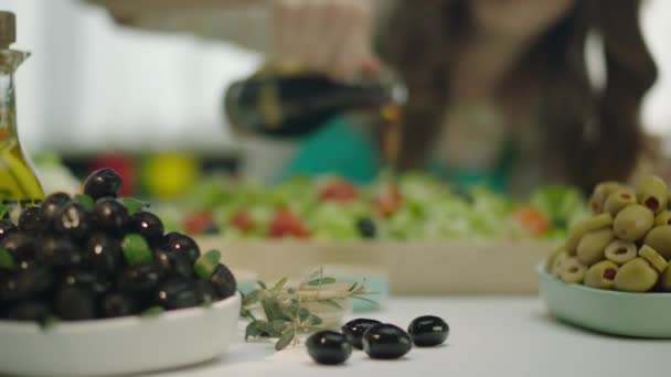 トマト ニンジン キャベツをオリーブオイルで混ぜ合わせたサラダを注ぐ女性 — ストック動画