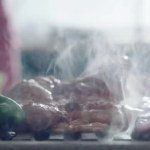 Close up of preparing meat and vegetables on grill