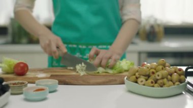 Ahşap tahta üzerinde salata için lahana kesme kadın yakın 