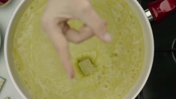 Slow Motion Female Hand Throwing Spicy Cube Broth — Stock Video