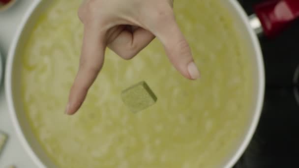 Slow Motion Female Hand Throwing Spicy Cube Broth — Stock Video