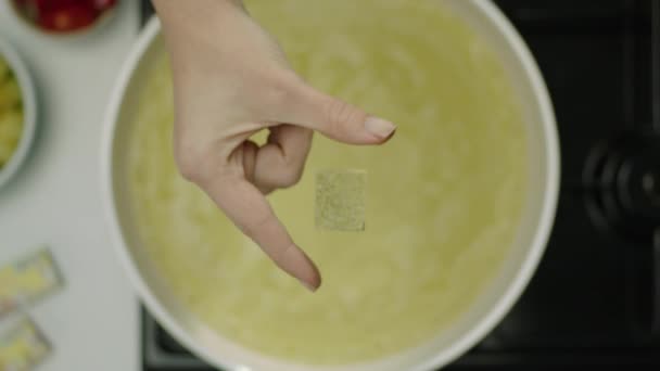 Slow Motion Female Hand Throwing Spicy Cube Broth — Stock Video