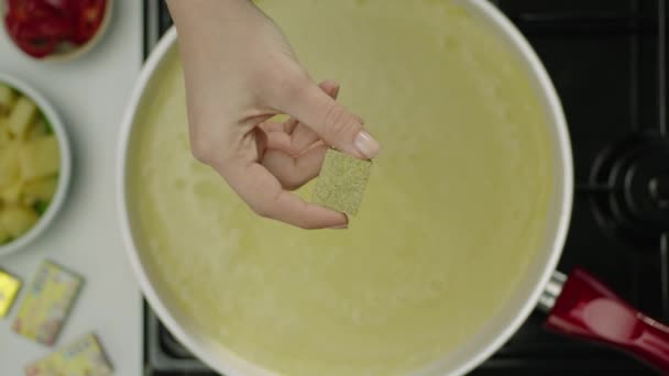 Slow Motion Female Hand Throwing Spicy Cube Broth — Stock Video