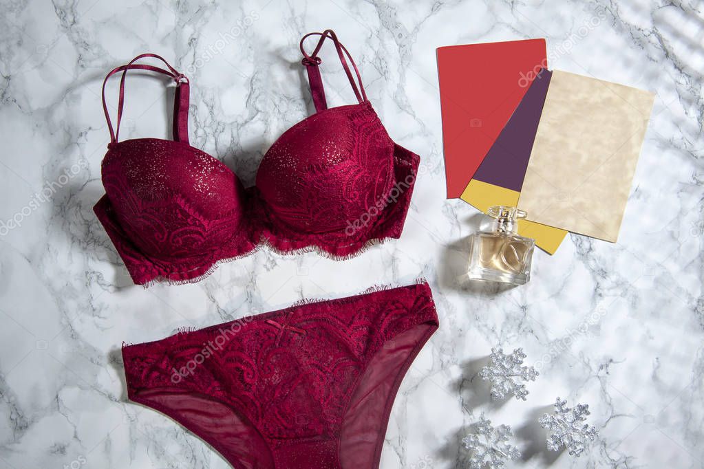 sexy elegant trendy feminine lingerie, cards and perfume on marble background