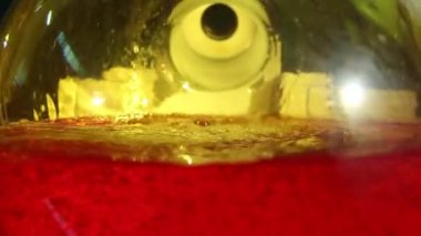 Laboratuvar camlarında köpüklerle kaynayan ve dönen kimyasal karışıma yakın çekim