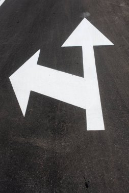 Two white arrows on asphalt. Street sign down for transportation clipart