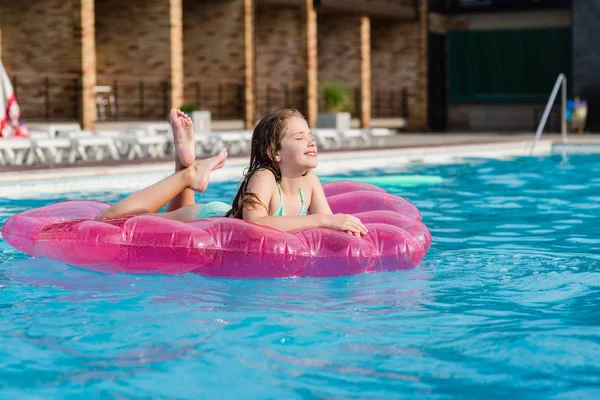 Adolescente no colchão de ar na piscina — Fotografia de Stock