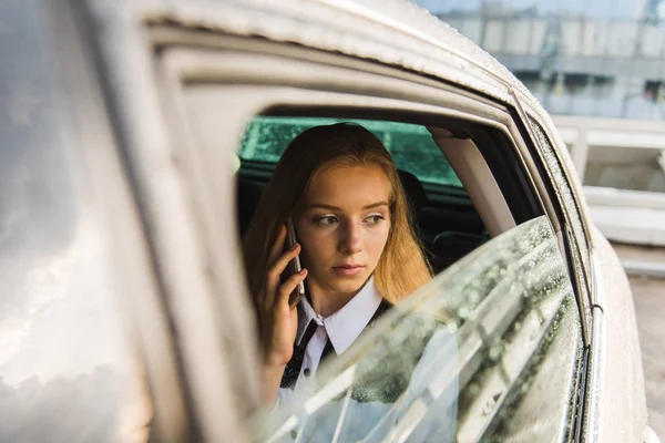Девушки говорят по телефону в дождливый день в машине — стоковое фото
