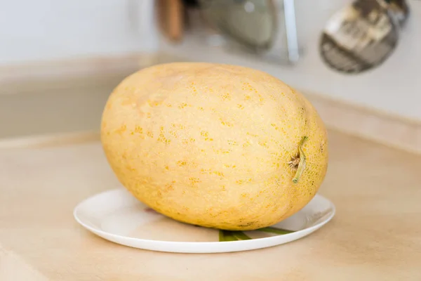 Melon close up at table and white saucer — Stock Photo, Image