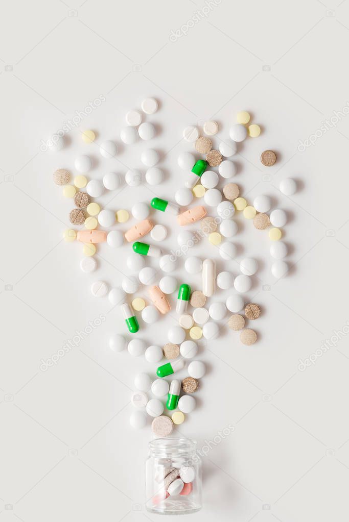 Colorful medication and pills on white background. Top view with copy space, flat lay.