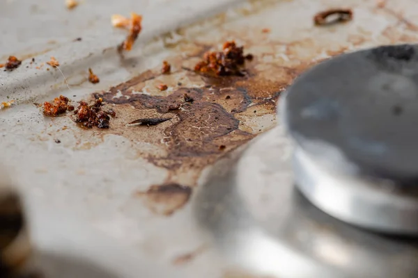 Dirty gas stove. The gas burner. Stains of fat and burned food.