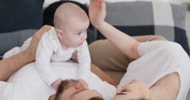 Young woman gentle touch infant girl.