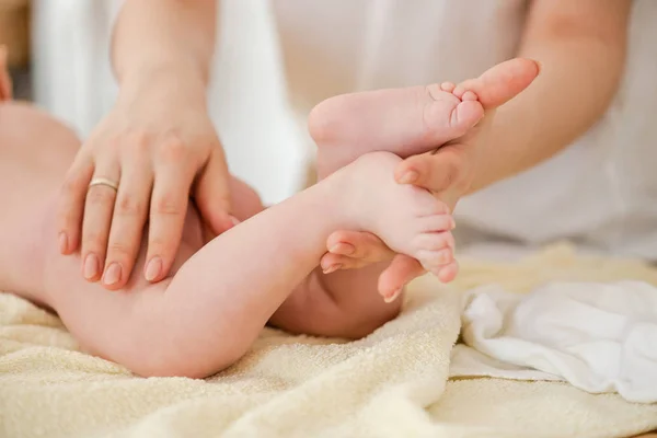 Ung kvinna massage försiktigt baby, närbild — Stockfoto