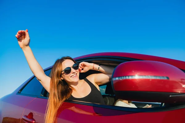 Young Female Sunglasses Put Out Hand Body Red Vehicle Blue — Stock Photo, Image