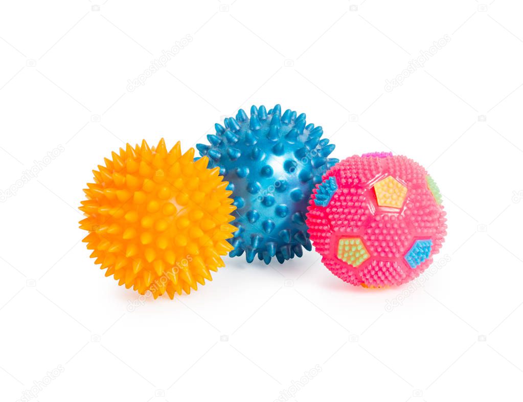Three rubber balls with thorns (pink, blue, yellow) isolated on white