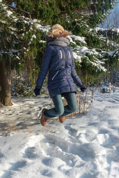 Happy Young Woman Fur Hat Jumps Green Fir Tree Outdoor — Stock Photo, Image
