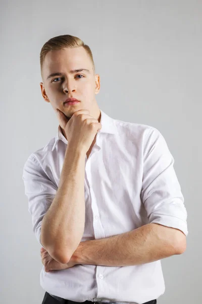 Young Handsome Man White Shirt Touches His Chin Studio — Stock Photo, Image