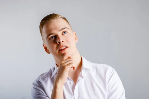 Young Handsome Man White Shirt Touches His Chin Dreams Studio — Stock Photo, Image