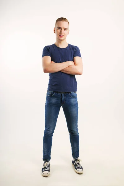 Young Handsome Man Blue Shirt Jeans Poses Crossed Arms White — Stock Photo, Image