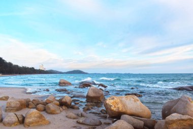  Sahilde batan güneş sırasında rüzgar serin eser. Kumlu zeminile güzel bulutlar ve kayalar