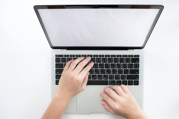 People hands are working on a laptop keyboard on a white backgro