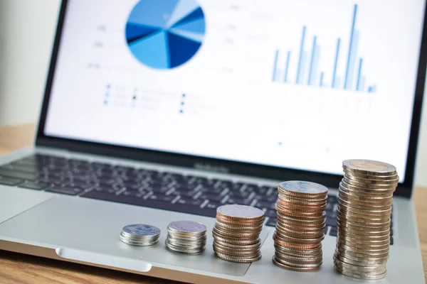 Stacked coins placed on the laptop as a background. Business fin — Stock Photo, Image